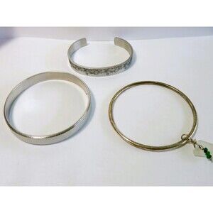 3 Silver tone bangle bracelets each different 1 etched 1 with charm 1 is glitter